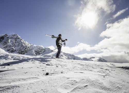 Man in snow holding a snowboard